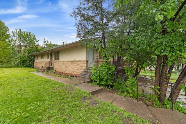 1022-1024 34th Ave N, Minneapolis, MN 55412 - view of home's exterior with brick siding and a lawn