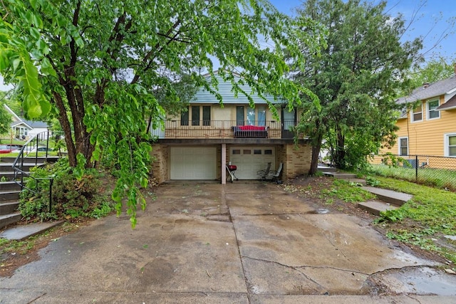 1022-1024 34th Ave N, Minneapolis, MN 55412 - view of front of property with a garage, brick siding, and driveway