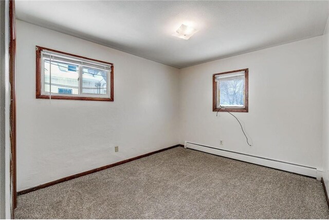 1022-1024 34th Ave N, Minneapolis, MN 55412 - empty room featuring a baseboard radiator, carpet, and baseboards