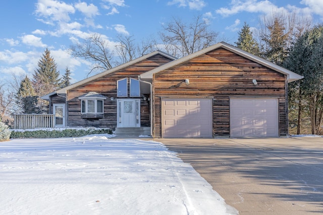 rustic home with concrete driveway and an attached garage