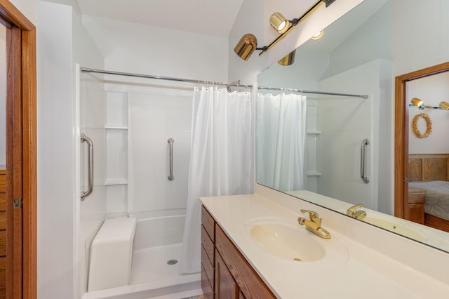 full bath with a stall shower, ensuite bath, and vanity