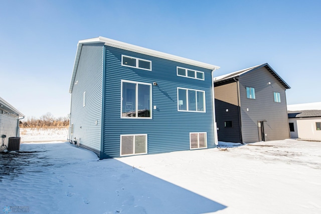 snow covered property featuring central air condition unit