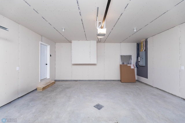 garage with electric panel and a garage door opener