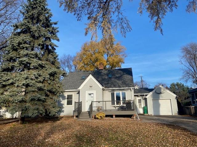 632 Morgan Ave S, Minneapolis, MN 55405 - view of front facade with asphalt driveway, a garage, and a deck