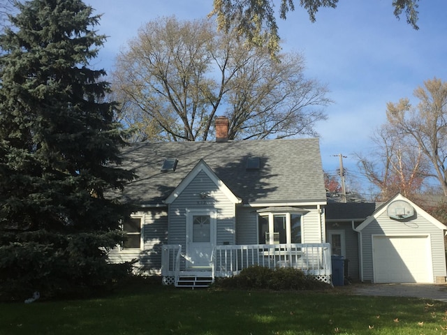 632 Morgan Ave S, Minneapolis, MN 55405 - view of front of home featuring a garage, a chimney, a front lawn, and driveway