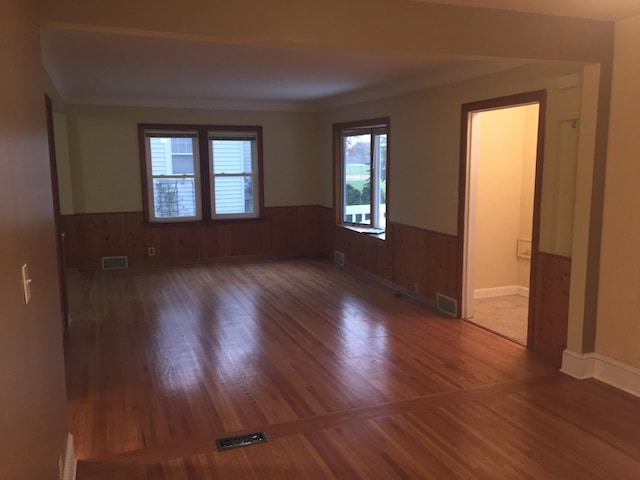 632 Morgan Ave S, Minneapolis, MN 55405 - unfurnished room with a wainscoted wall, wood finished floors, and wood walls