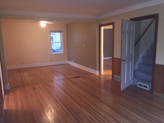 632 Morgan Ave S, Minneapolis, MN 55405 - unfurnished room featuring wood finished floors, stairs, and baseboards