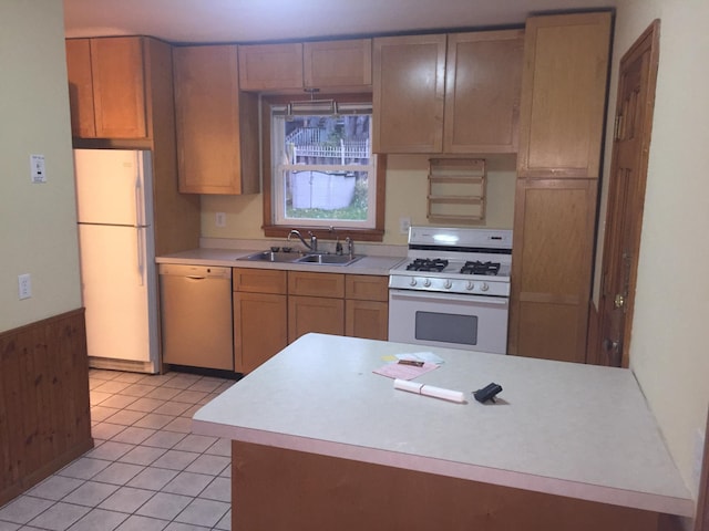 632 Morgan Ave S, Minneapolis, MN 55405 - kitchen with white appliances, a sink, light countertops, wood walls, and wainscoting