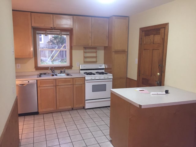 632 Morgan Ave S, Minneapolis, MN 55405 - kitchen with dishwasher, white range with gas cooktop, a sink, light countertops, and a peninsula