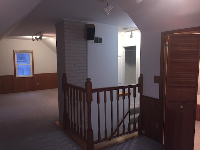 632 Morgan Ave S, Minneapolis, MN 55405 - hallway featuring an upstairs landing, carpet flooring, rail lighting, a wainscoted wall, and wooden walls