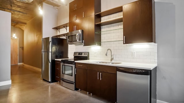 kitchen featuring decorative backsplash, appliances with stainless steel finishes, open shelves, and a sink