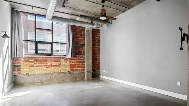 empty room featuring baseboards and concrete flooring