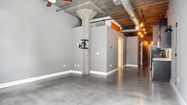 garage featuring visible vents, baseboards, and a sink