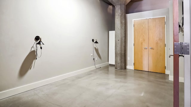 interior space with concrete floors and baseboards