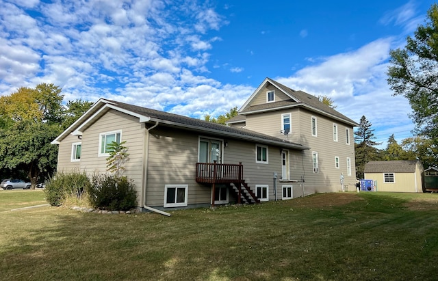 back of house with a storage unit, a lawn, and an outbuilding