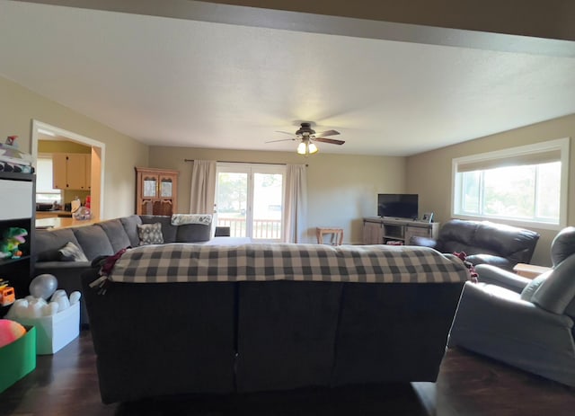 living area with dark wood-style floors and a ceiling fan