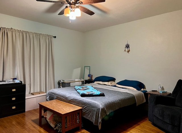 bedroom with ceiling fan and light wood-style flooring