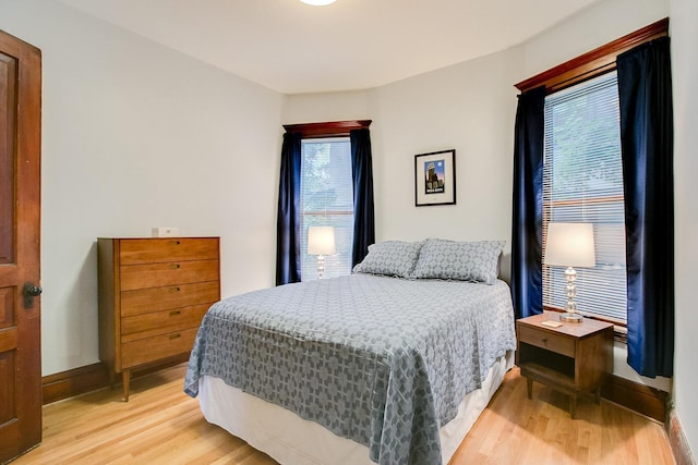 bedroom featuring light wood-style flooring and baseboards