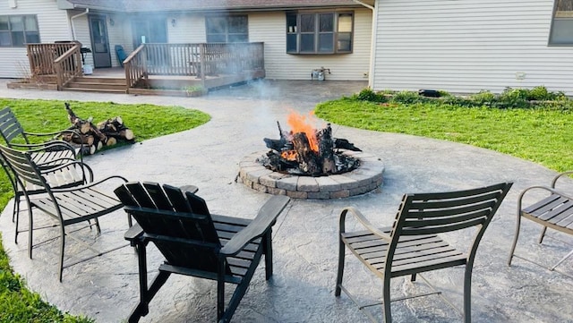 view of patio with an outdoor fire pit and a wooden deck