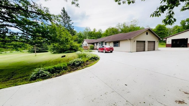 view of front of home featuring a detached garage and a front yard