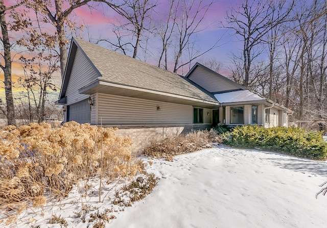 view of front of property with roof with shingles and an attached garage