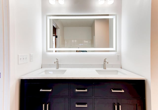 bathroom featuring double vanity and a sink