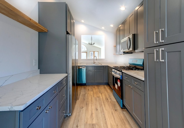 15153 Cates Lake Dr, Prior Lake, MN 55372 - kitchen with stainless steel appliances, open shelves, a sink, light wood-style floors, and light stone countertops