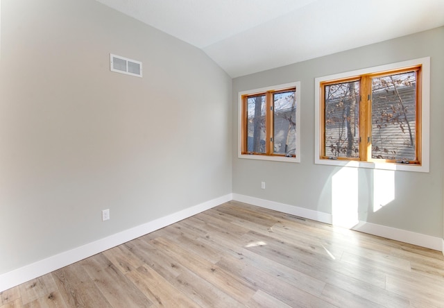 15153 Cates Lake Dr, Prior Lake, MN 55372 - empty room featuring baseboards, vaulted ceiling, and light wood-type flooring