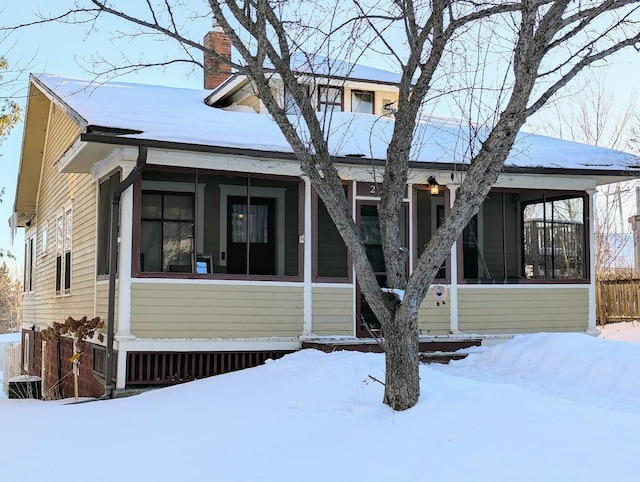 view of front of house featuring a chimney