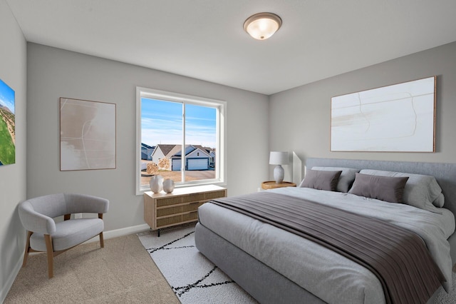 bedroom featuring baseboards and light colored carpet