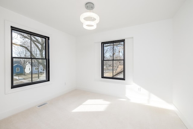 4129 Utica Ave S, Saint Louis Park, MN 55416 - unfurnished room featuring carpet and a chandelier