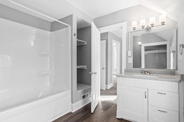 full bathroom featuring visible vents, shower / bathing tub combination, vanity, and wood finished floors