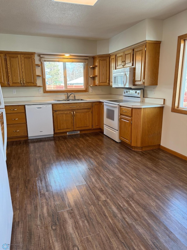 kitchen featuring a sink, open shelves, white appliances, and light countertops