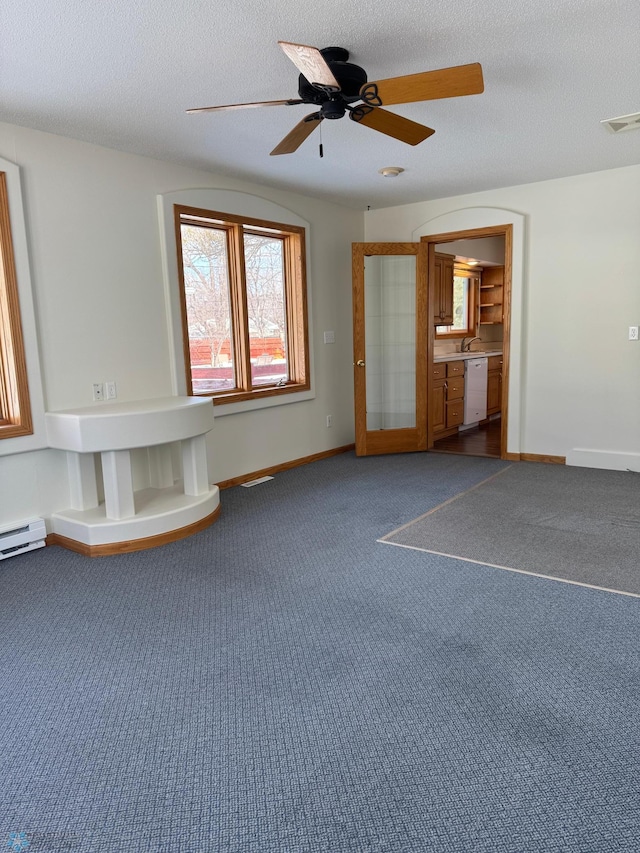 unfurnished living room featuring carpet floors, baseboards, visible vents, and a textured ceiling