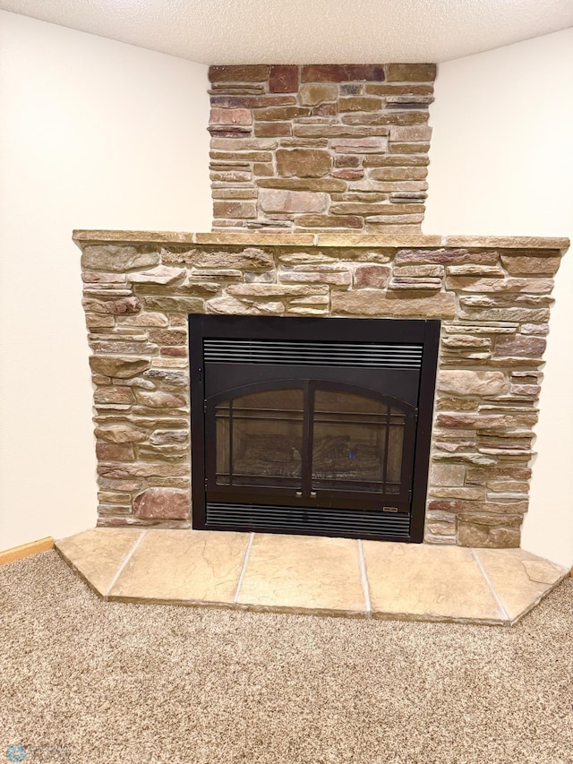 details with a textured ceiling, a stone fireplace, and carpet flooring