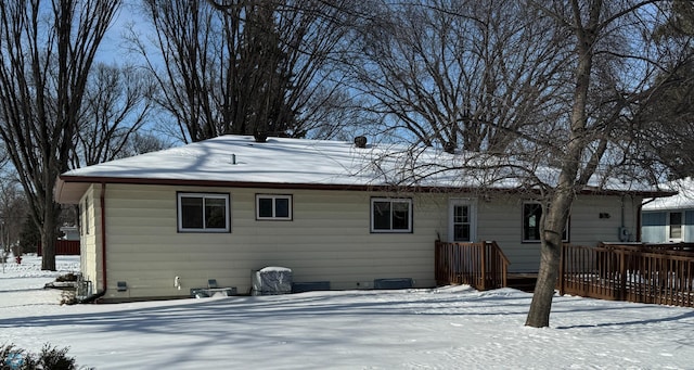 view of snow covered rear of property