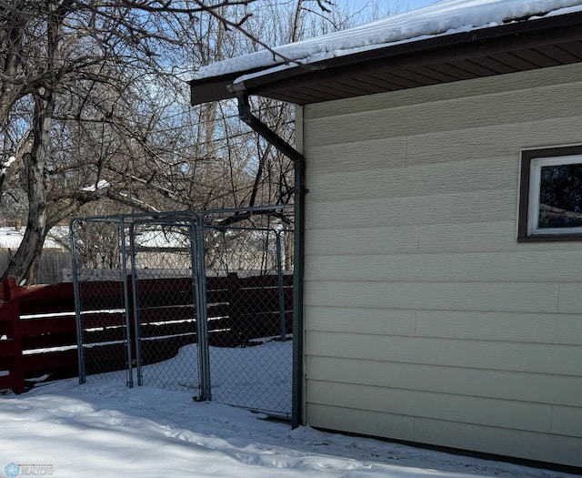 view of snowy exterior with fence