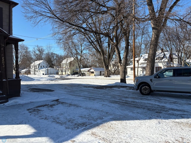 yard covered in snow with a residential view