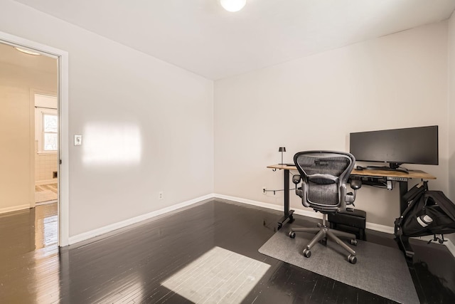 home office featuring baseboards and dark wood-style flooring