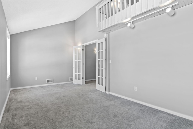 carpeted empty room with french doors, visible vents, and baseboards