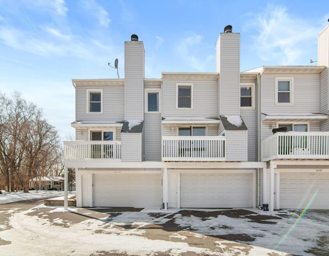 back of property featuring a chimney and a balcony