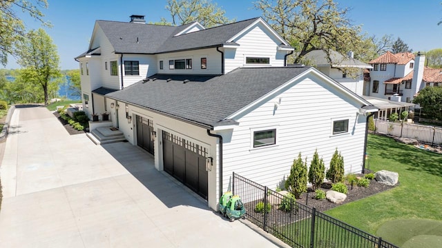4889 Lake Harriet Pkwy, Minneapolis, MN 55419 - view of front of property with a shingled roof, driveway, an attached garage, and a chimney