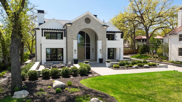 4889 Lake Harriet Pkwy, Minneapolis, MN 55419 - french country inspired facade featuring a chimney, a front yard, and a patio area