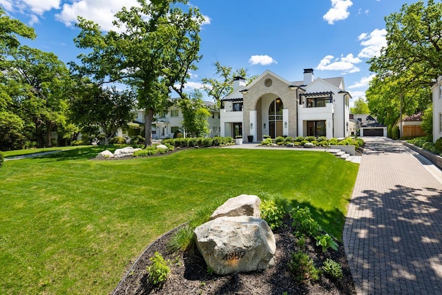 4889 Lake Harriet Pkwy, Minneapolis, MN 55419 - view of front of house featuring a front lawn, a chimney, and stucco siding