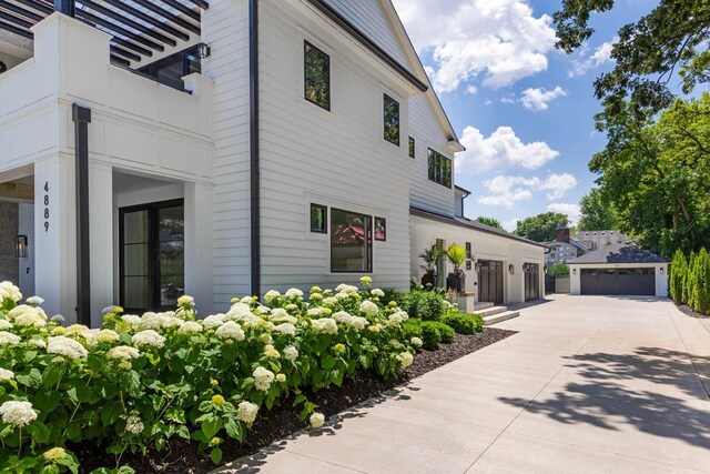 4889 Lake Harriet Pkwy, Minneapolis, MN 55419 - view of side of home with an outdoor structure and a garage