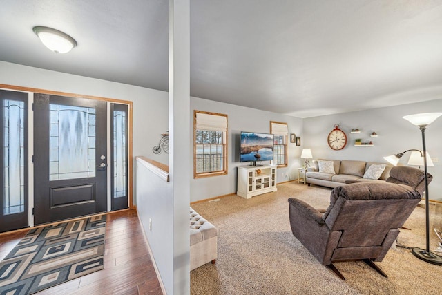 entryway featuring baseboards and wood finished floors