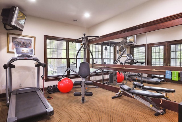 exercise room featuring recessed lighting, french doors, baseboards, and a healthy amount of sunlight