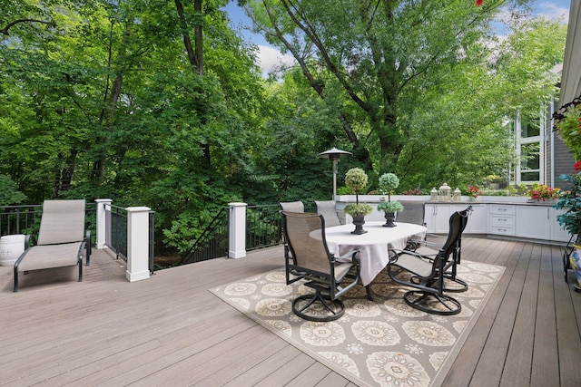 wooden deck featuring outdoor dining area