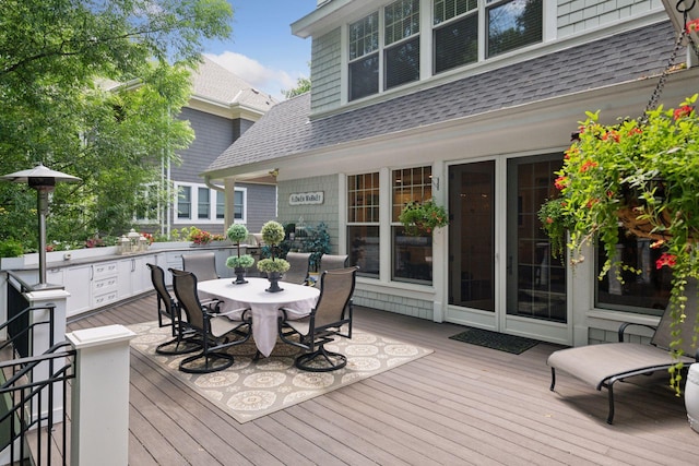 deck featuring exterior kitchen and outdoor dining area