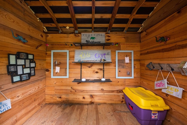 interior space featuring wooden walls and wood finished floors